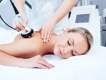 A woman getting her back examined by an esthetician.