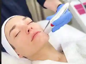 A man getting his face waxed at the spa