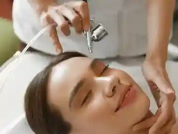 A woman getting her face waxed at the spa.