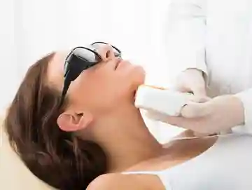 A woman getting her teeth checked by an esthetician.