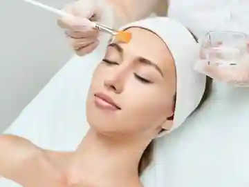 A woman getting her face waxed at the spa