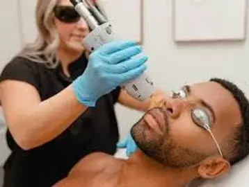 A man getting his face waxed by an esthetician.