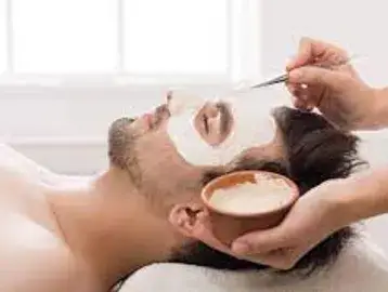 A man getting his face waxed at the spa